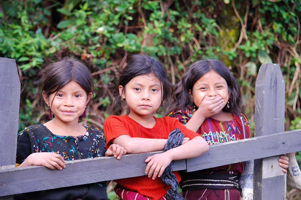 Ixil Mayan girls pose for a photo in Guatemala. / USAID